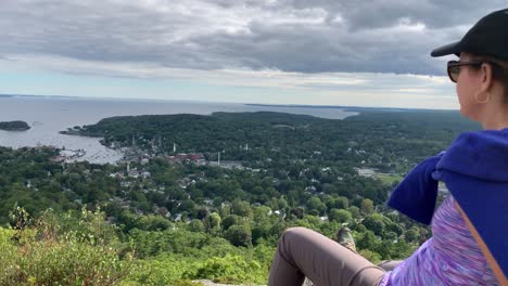 4K-Frau-Blickt-Von-Der-Spitze-Des-Mount-Battie-Auf-Camden-Maine-Herab