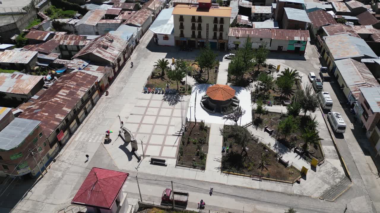 Low aerial approaches plaza in charming mtn town, Cajatambo Peru