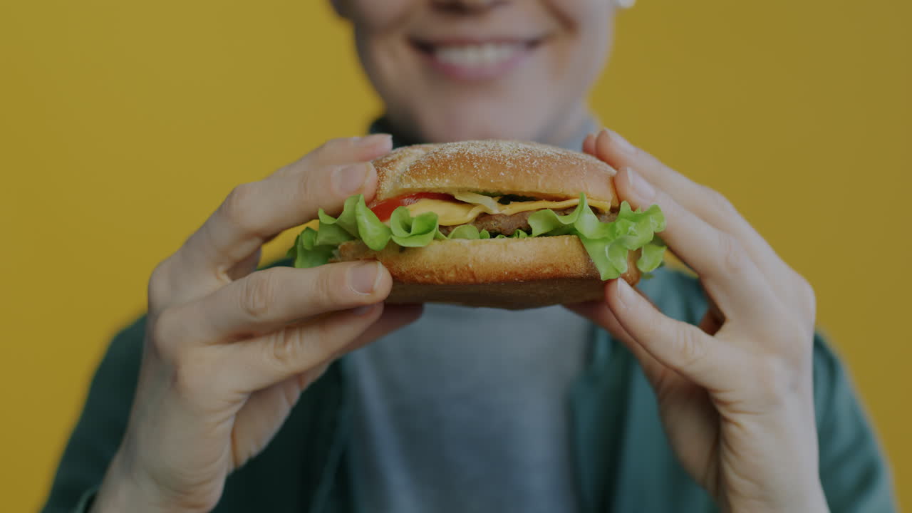 Woman Holding a Delicious Hamburger