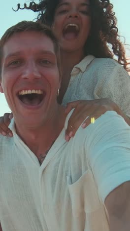 joyful couple captures laughter under the sun during a beach getaway
