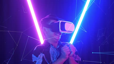 vr, futuristic, entertainment concept. excited asian boy using virtual reality headset and feel scary with neon light at the background