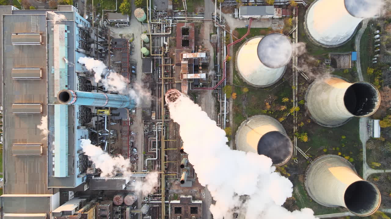 Power station with a lot of tubes and facilities in Bucharest at sunset, a lot of foam. View from the drone, top view. Romania
