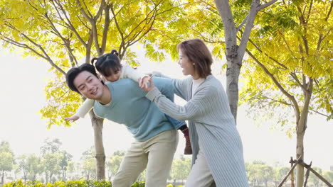 happy family in the outdoor outing having a picnic in the park, concept of destination, family travel and summer vacation or holidays