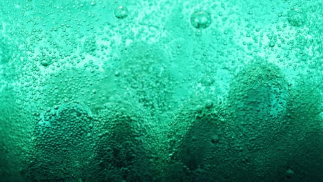 macro-shot-of-big-blue-bubbles-on-ground-of-water-and-many-small-bubbles-sparkling