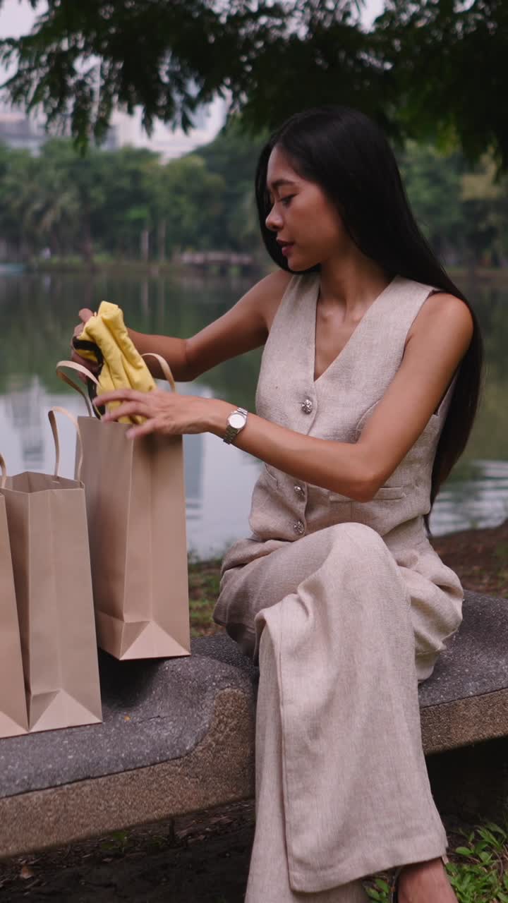 Woman holding yellow t-shirt outdoors