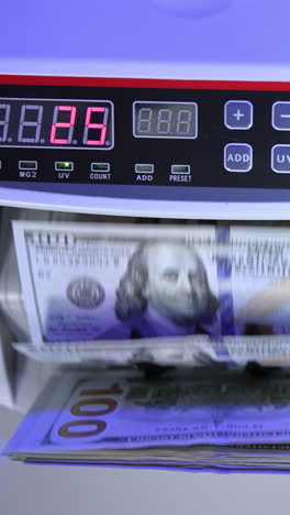 counting us dollars with a bill counter