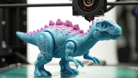 a vibrant blue dinosaur toy: an intriguing display of 3d printing technology captured in dynamic action frames