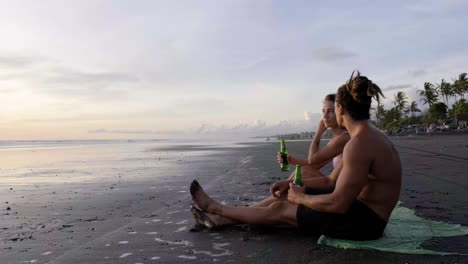 Young-couple-sitting-on-the-sand