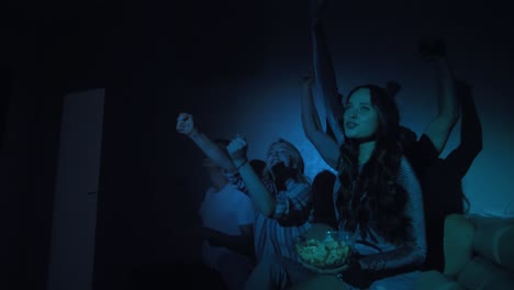 jóvenes amigas bonitas viendo una película de televisión juntas
