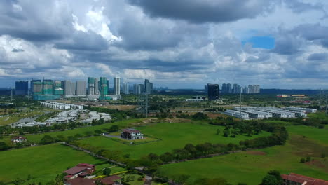 Aerial-shots-of-a-wide-landscape-with-a-houses-and-blue-sky-in-the-background