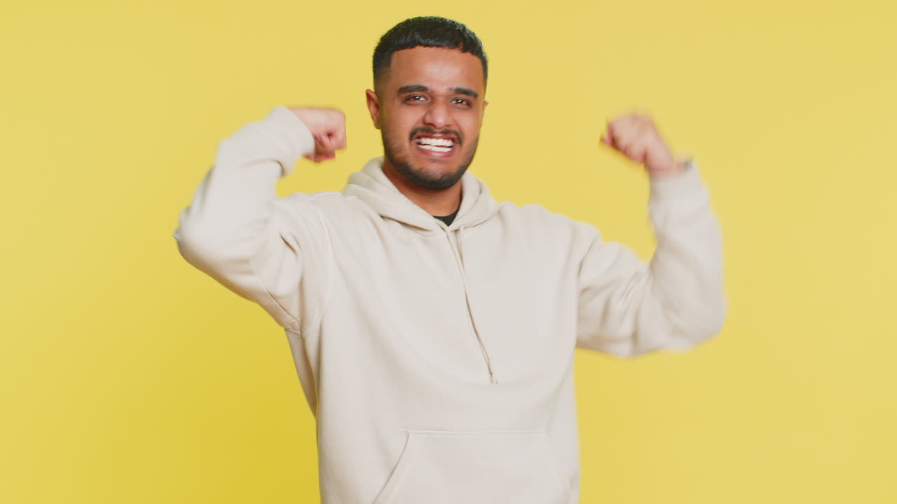 Man looking confident showing biceps feeling power strength to fight for rights success win
