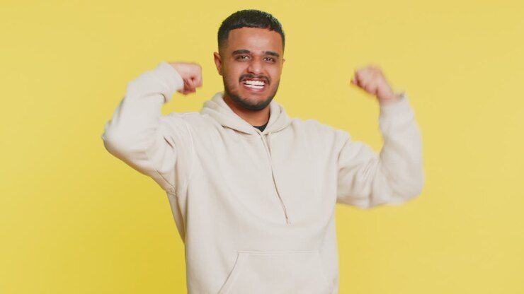 Man looking confident showing biceps feeling power strength to fight for rights success win