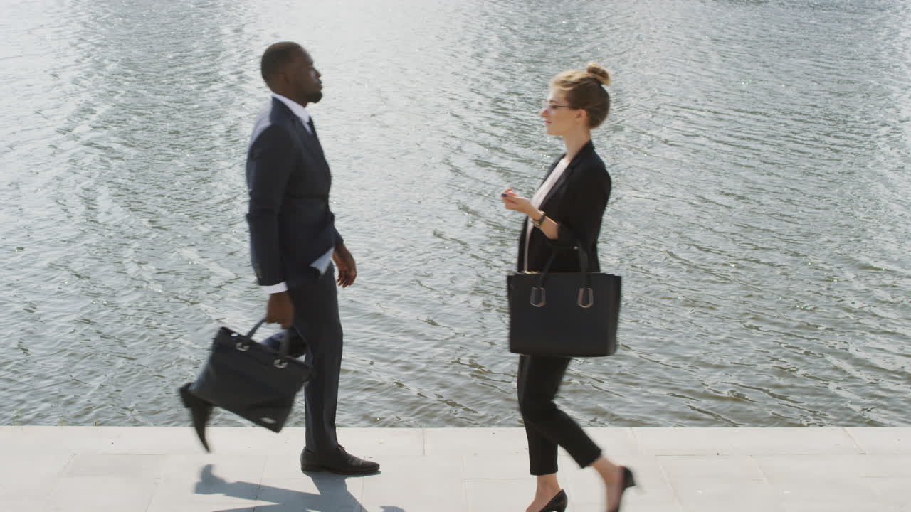 Business People Walking Near River