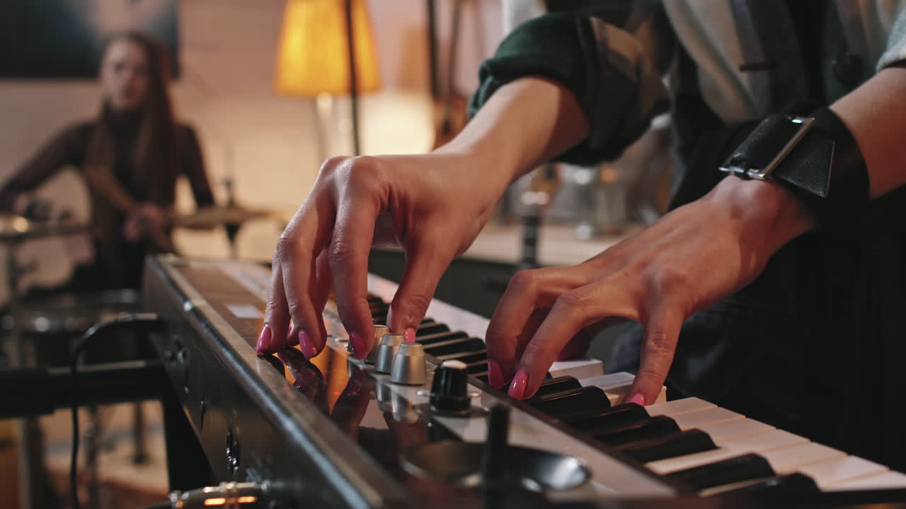 Female Pianist Adjusting Sound On Electronic Piano