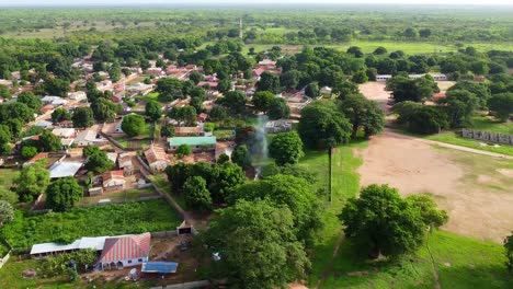 aerial panoramic view of african cultural village with visible smoke from one household