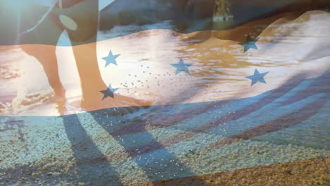 honduras flag animation overlaying people walking on sandy beach during sunset
