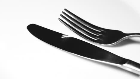 knife and fork on white surface close up video