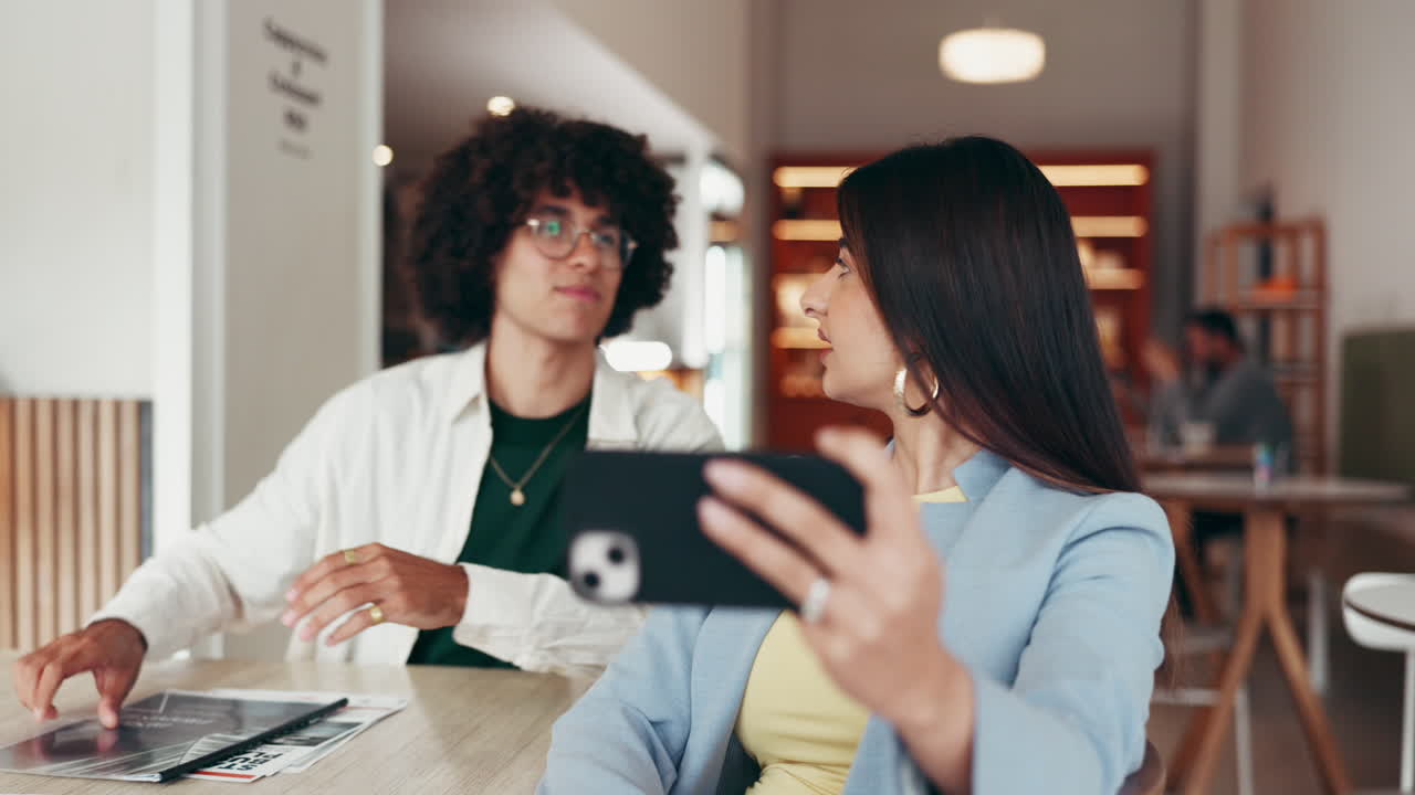 Two People Smiling and Taking a Selfie in a Cafe