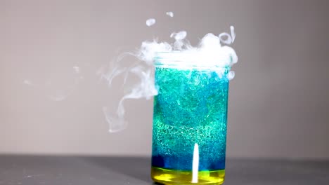 bubbling liquid with smoke in a glass container