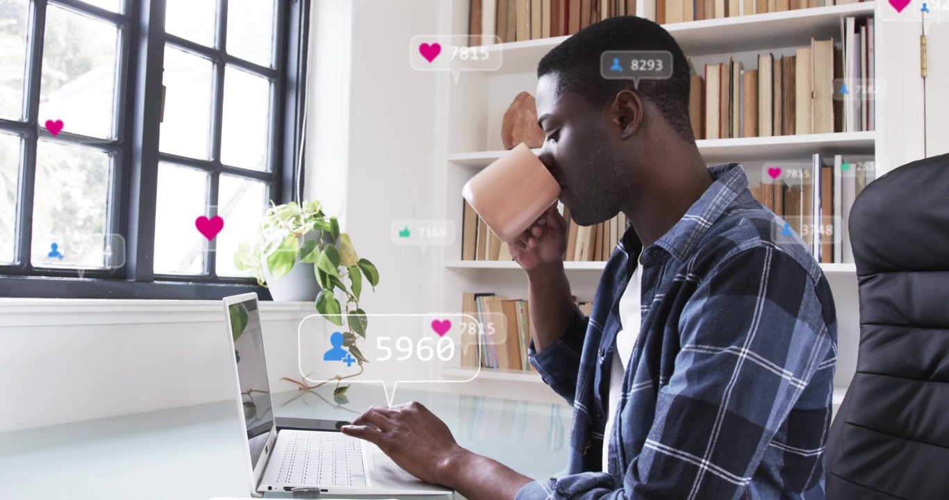Man typing at laptop spawning floating social media counters climbing while sipping coffee