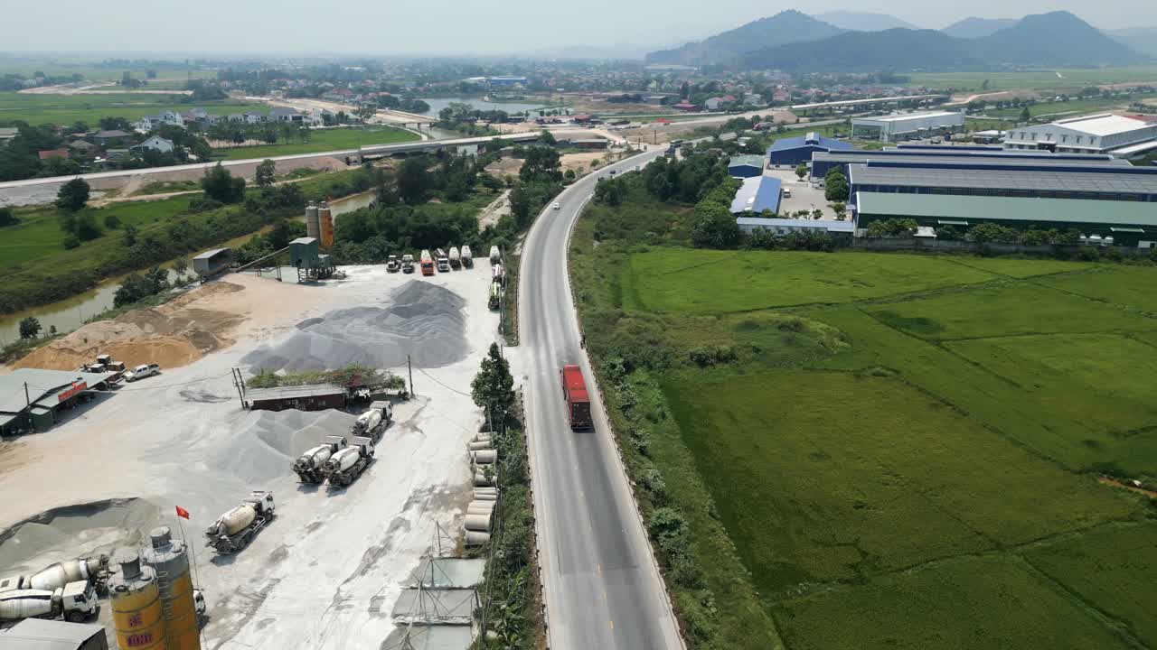 Aerial view of a highway with construction sites and farmland