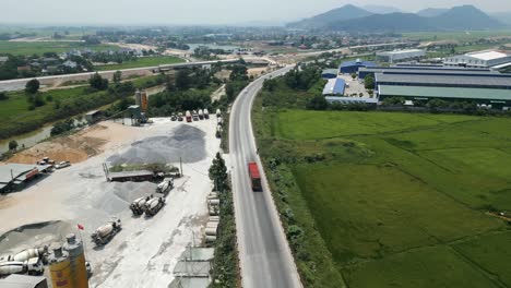 aerial view of a highway with construction sites and farmland