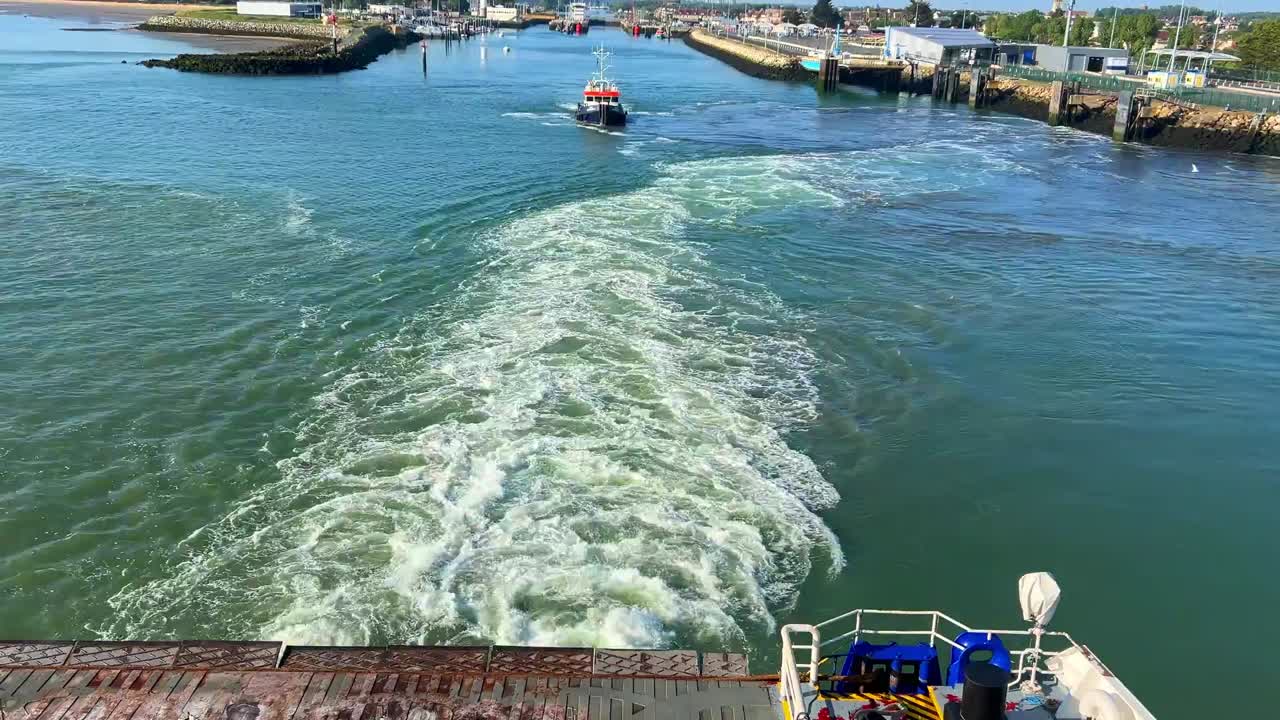 Sailing away from Ouistreham harbour with wake into the Channel
