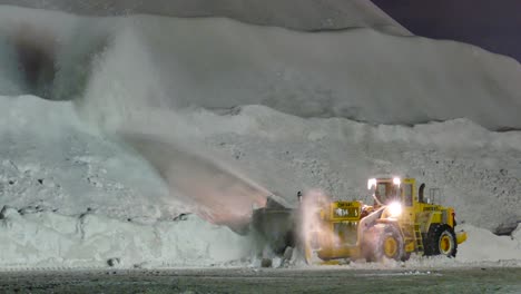 Following-shot-of-cleaning-the-city-from-snow-in-the-winter-with-the-help-of-special-equipment-vehicle