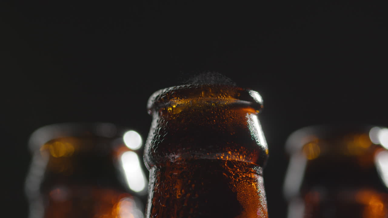 Close Up Of Condensation Droplets On Neck Of Bottles Of Cold Beer Or Soft Drinks With Water Vapour After Opening 1