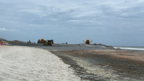 wide view, beach replenishment equipment pumping and spreading sand