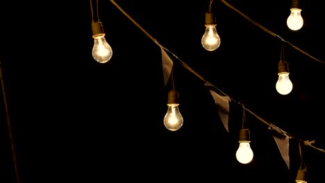 4K Light bulbs garland hanging in the air, Pan shot