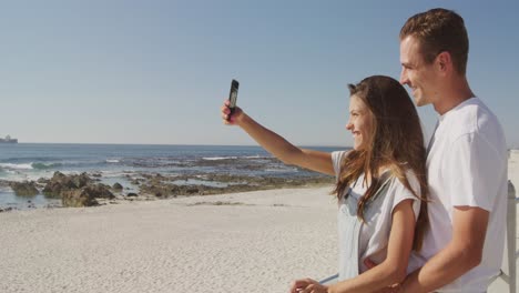 Young-adult-couple-relaxing-at-the-seaside