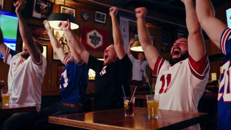 sports fans celebrating at a bar