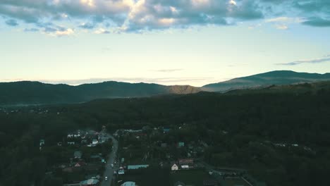 aerial view tourist city in the mountains under the clouds on the sunset