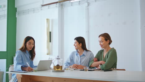 friendly boss talking employees on team meeting. corporate mentor discussing