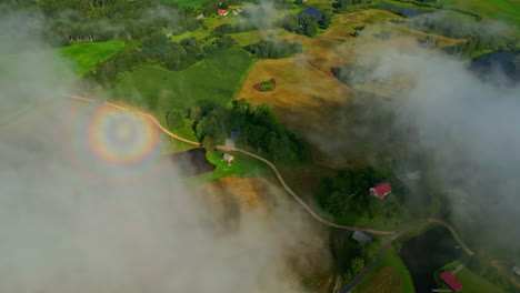 Round-rainbow-cloud-fog-mist,-aerial-rural-agriculture-land-field-multicolor