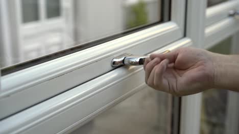 White-window-being-closed-and-locked,-conservatory