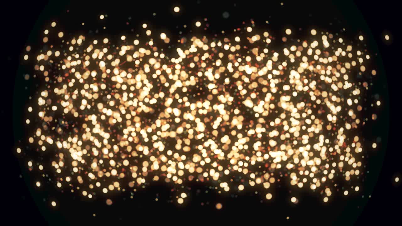 황금빛 빛 입자가 검은 바탕에 보케를 빛니다.
