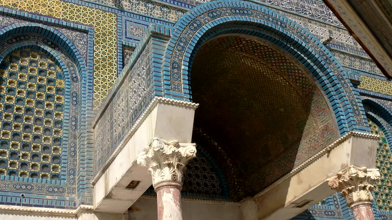 panning close up of an arched entrance to dome of the rock mosque in jerusalem