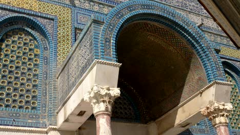 panning close up of an arched entrance to dome of the rock mosque in jerusalem