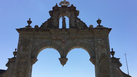 Arcos-de-Zapopan-limestone-monument-with-tourist,-Guadalajara,-Mexico