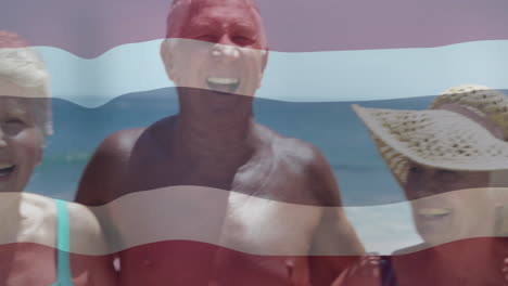 Waving flag animation overlay, elderly couple smiling on beach day