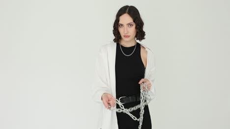 young woman holding a chain on white background