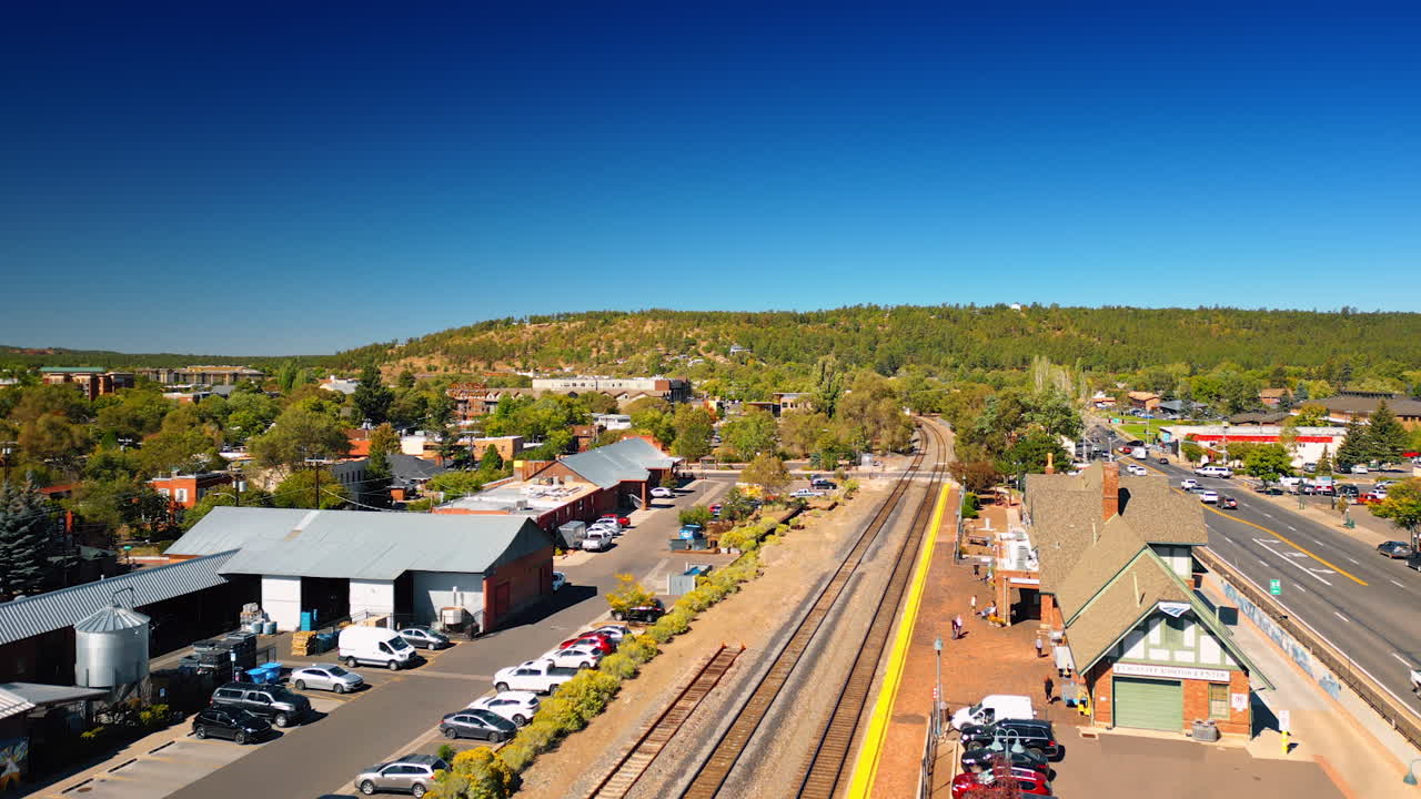 Flagstaff, USA, 24 August 2025: Rising over the railway station of Flagstaff, Arizona, USA. Lots of cars are parked nearby
