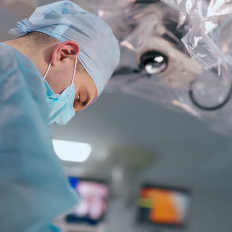 professional doctor and female assistant in surgery room. surgeon in blue uniform and mask perform an operation with the help of a nurse. medical concept.