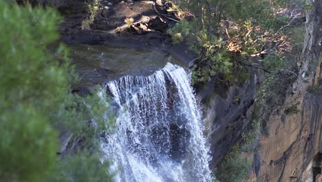 water flowing over the edge of australian waterfall