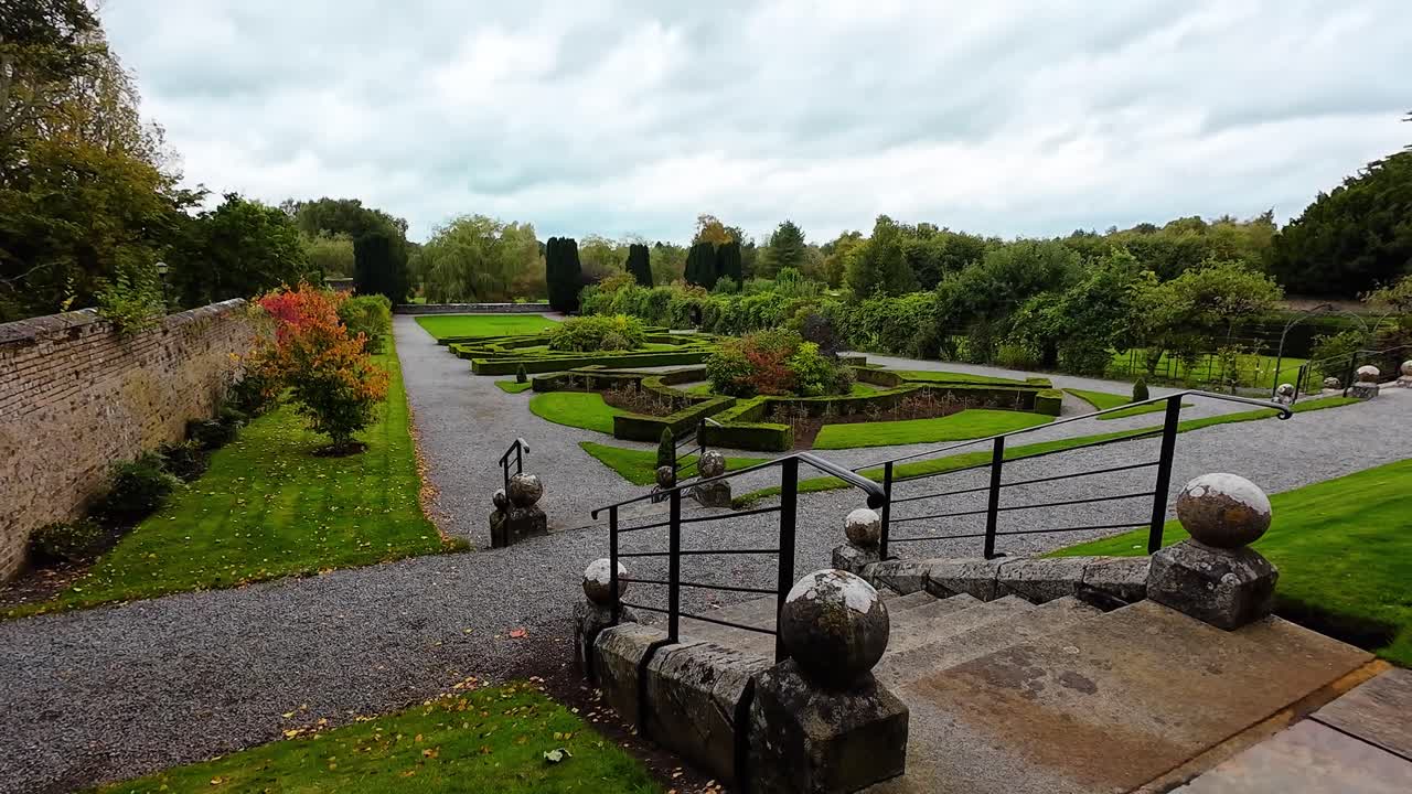 Beautiful Formal Garden with Stone Steps and Iron Railing