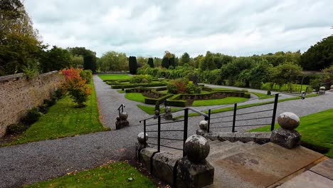 beautiful formal garden with stone steps and iron railing