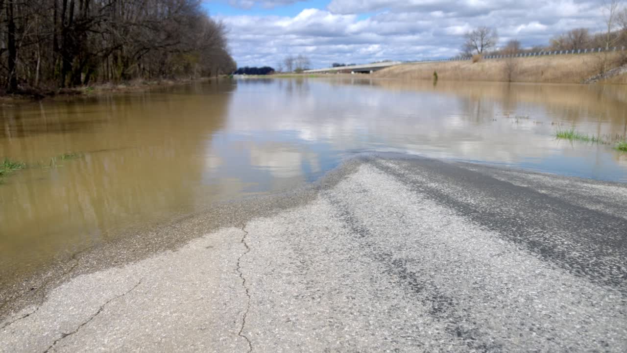 Rural southern Indiana flood damage with gimbal video walking forward low.