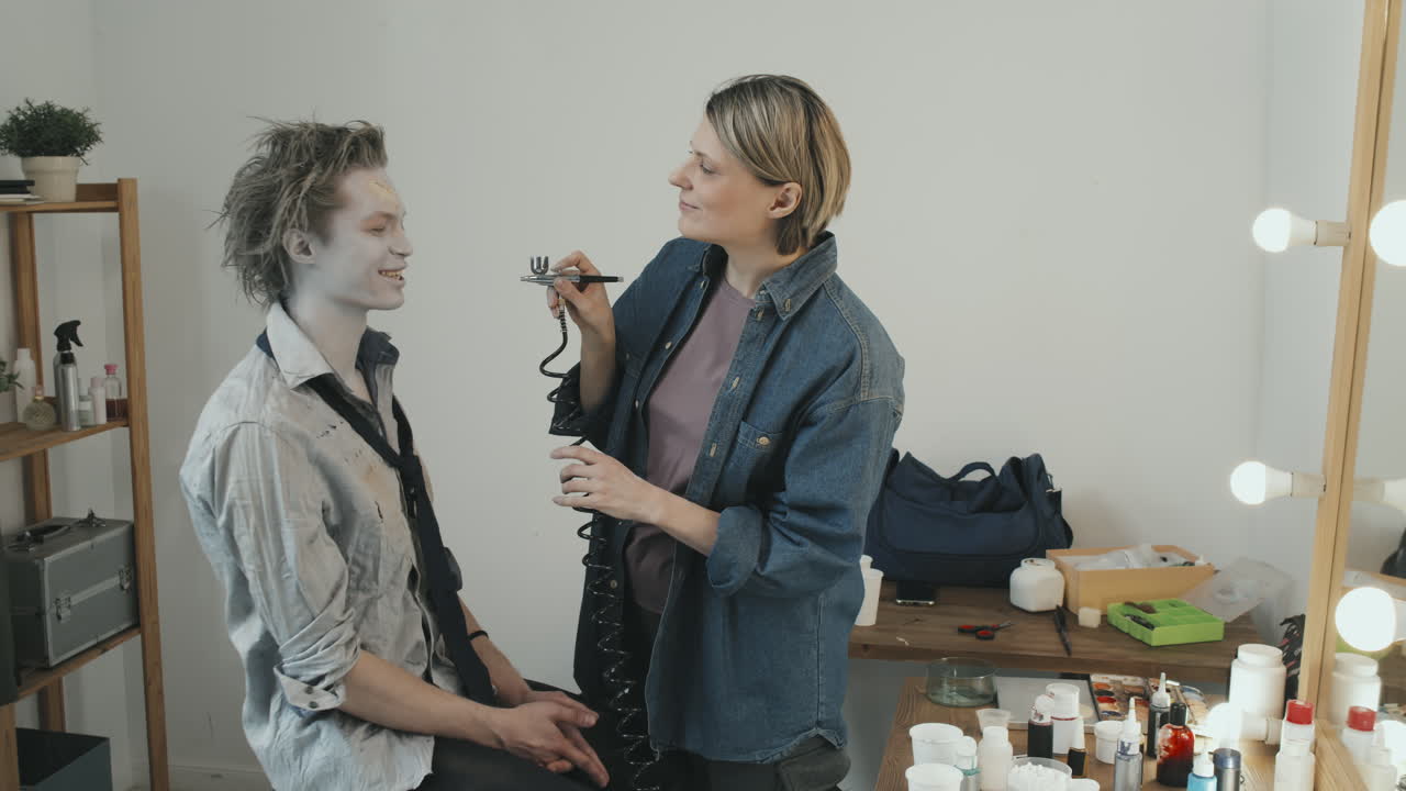Woman Applying Zombie Makeup on Man